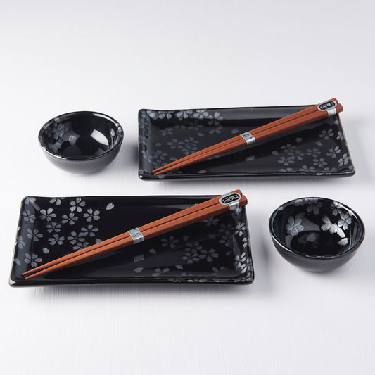 Four-piece Japanese sushi set with chopsticks, black sakura plate, and dipping bowls in gift box