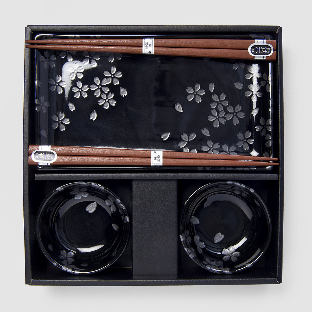 Four-piece Japanese sushi set with chopsticks, black sakura plate, and dipping bowls in gift box