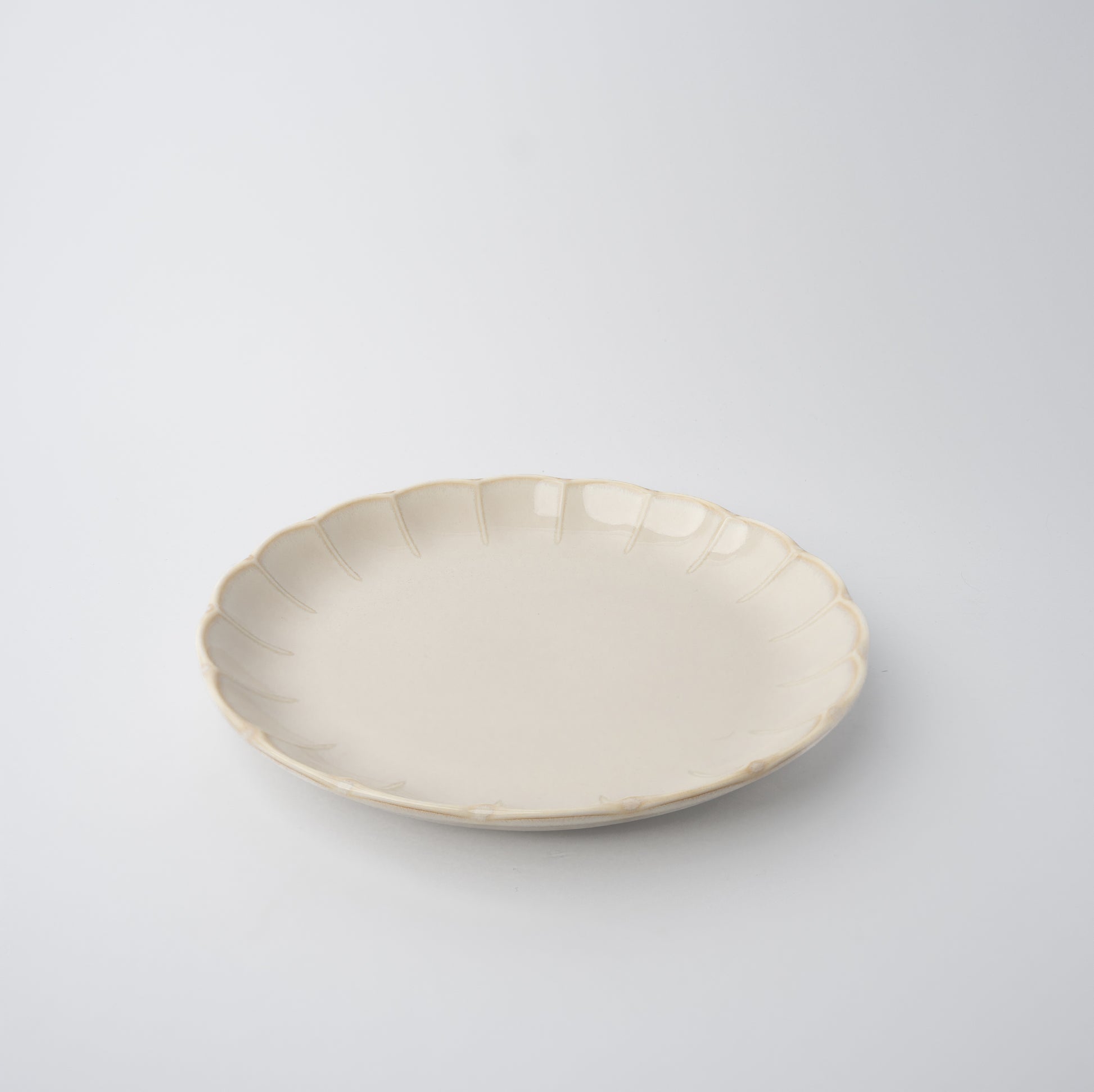 Handmade 21cm ceramic side plate in ivory glaze with scalloped edge