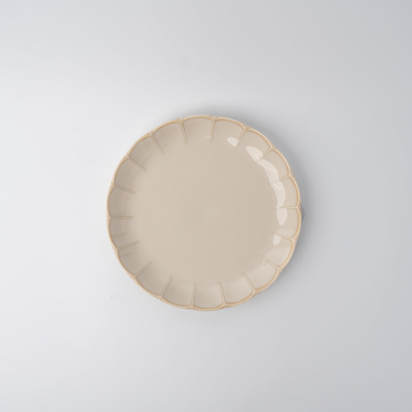 Handmade 21cm ceramic side plate in ivory glaze with scalloped edge