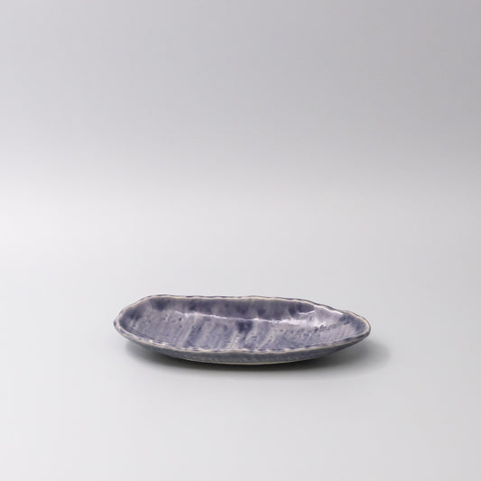 Purple ceramic dish on a light gray background