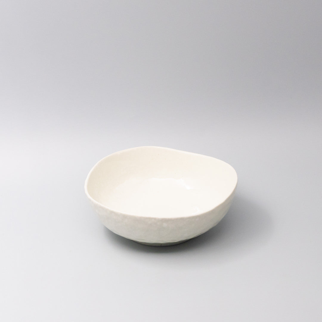 White ceramic bowl with organic curved shape and smooth finish