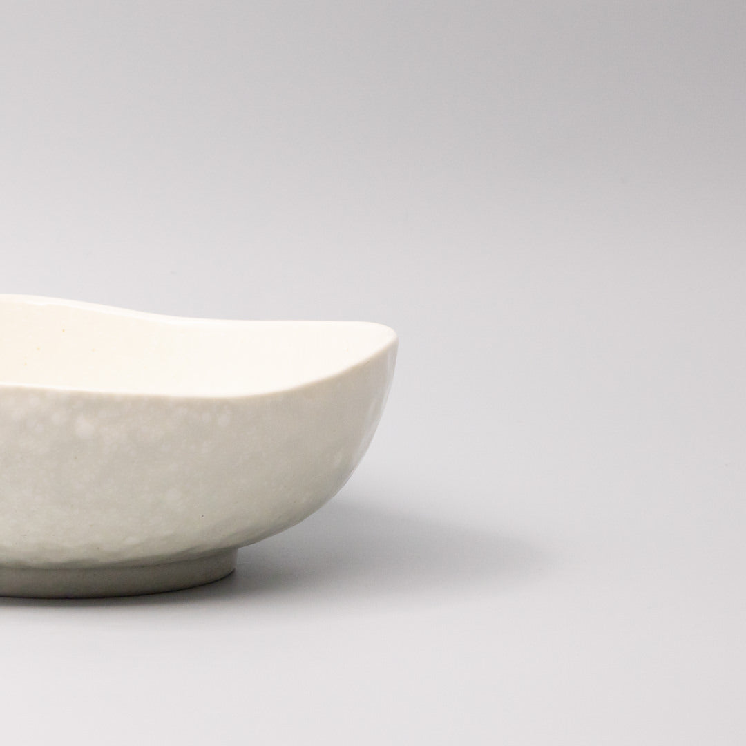 White ceramic bowl with organic curved shape and smooth finish