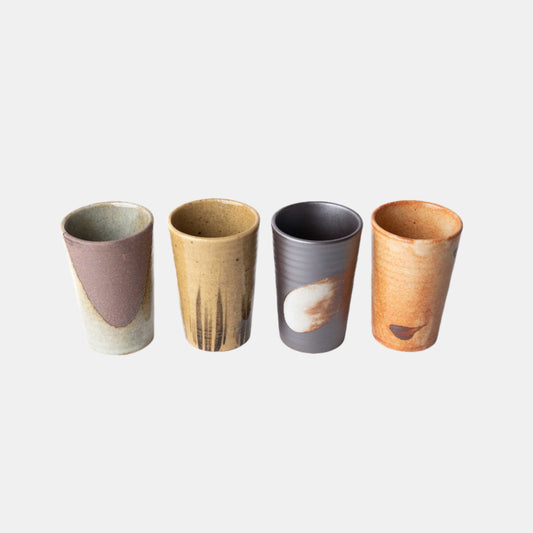 Set of four handmade ceramic cups with straight sides in assorted earthy glazes