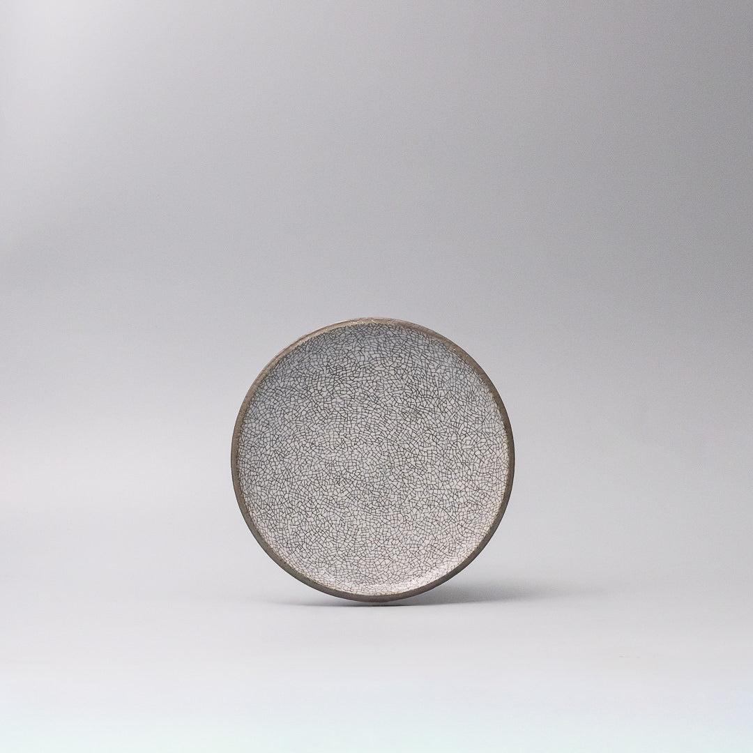 crazed grey ceramic plate top view