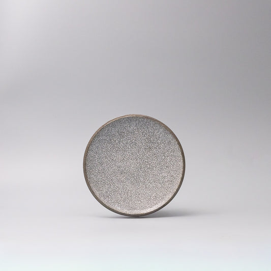 crazed grey ceramic plate top view