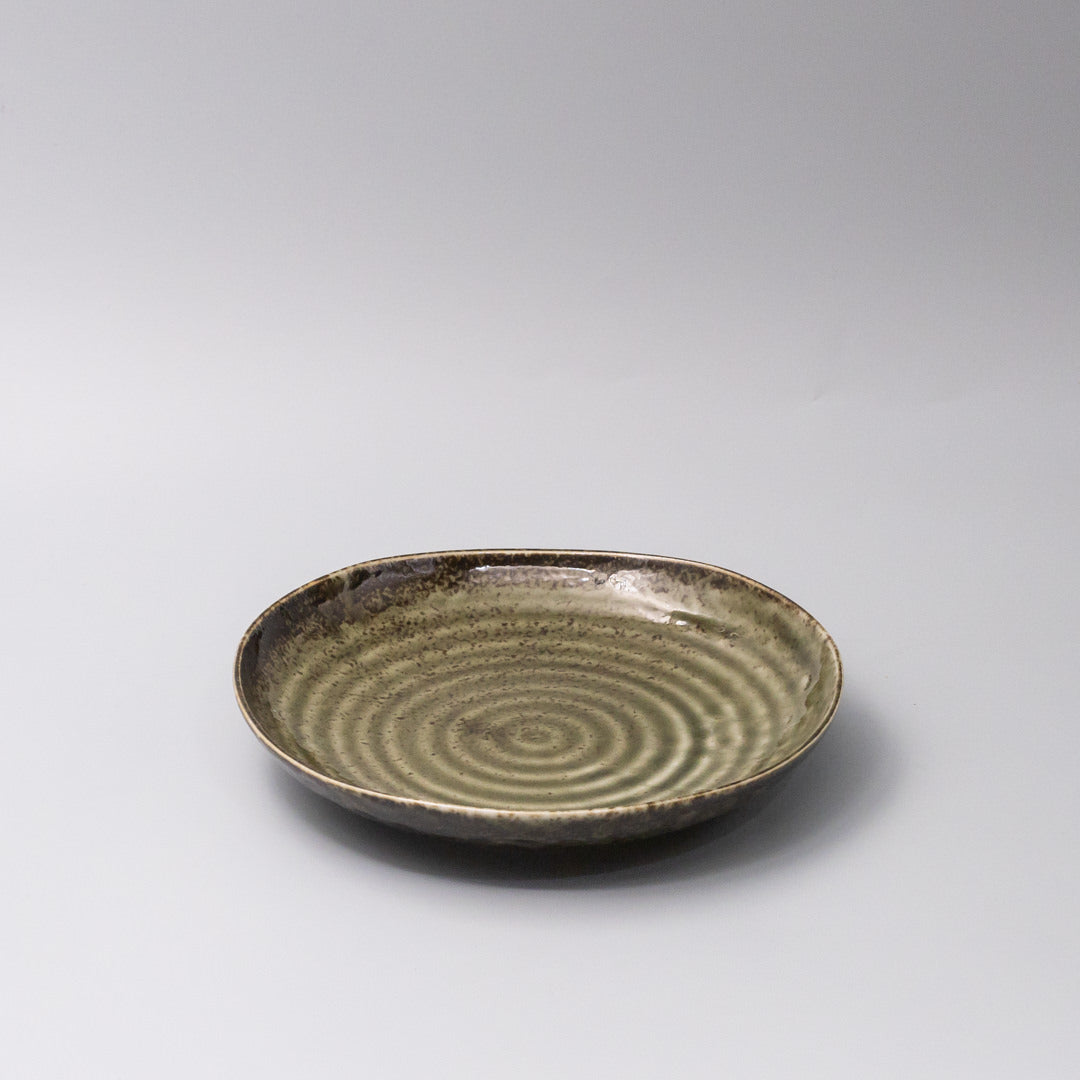 Organic sage green glaze ceramic dinner plate 45 degree view Japanese tableware