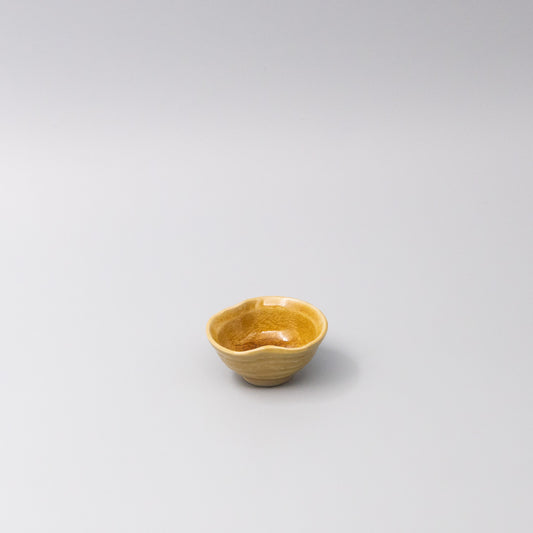 Small sauce bowl in warm amber glaze with softly curved edges