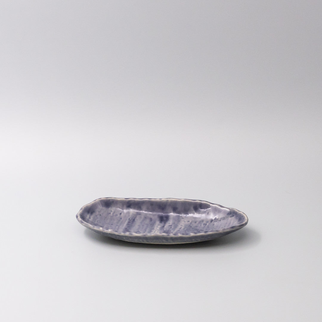 Purple ceramic dish on a light gray background