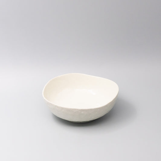 White ceramic bowl with organic curved shape and smooth finish