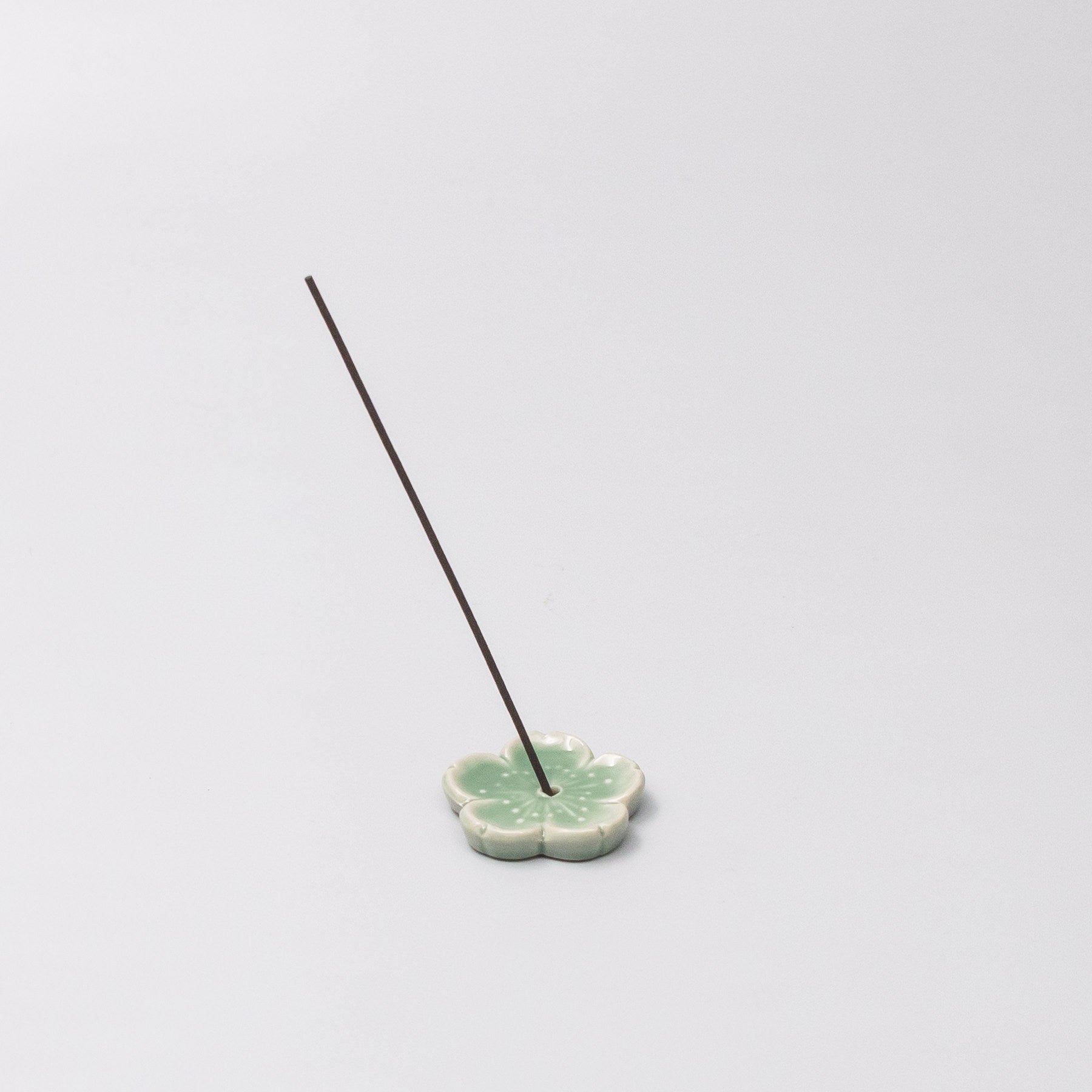 Japanese ceramic incense holder with green Sakura design